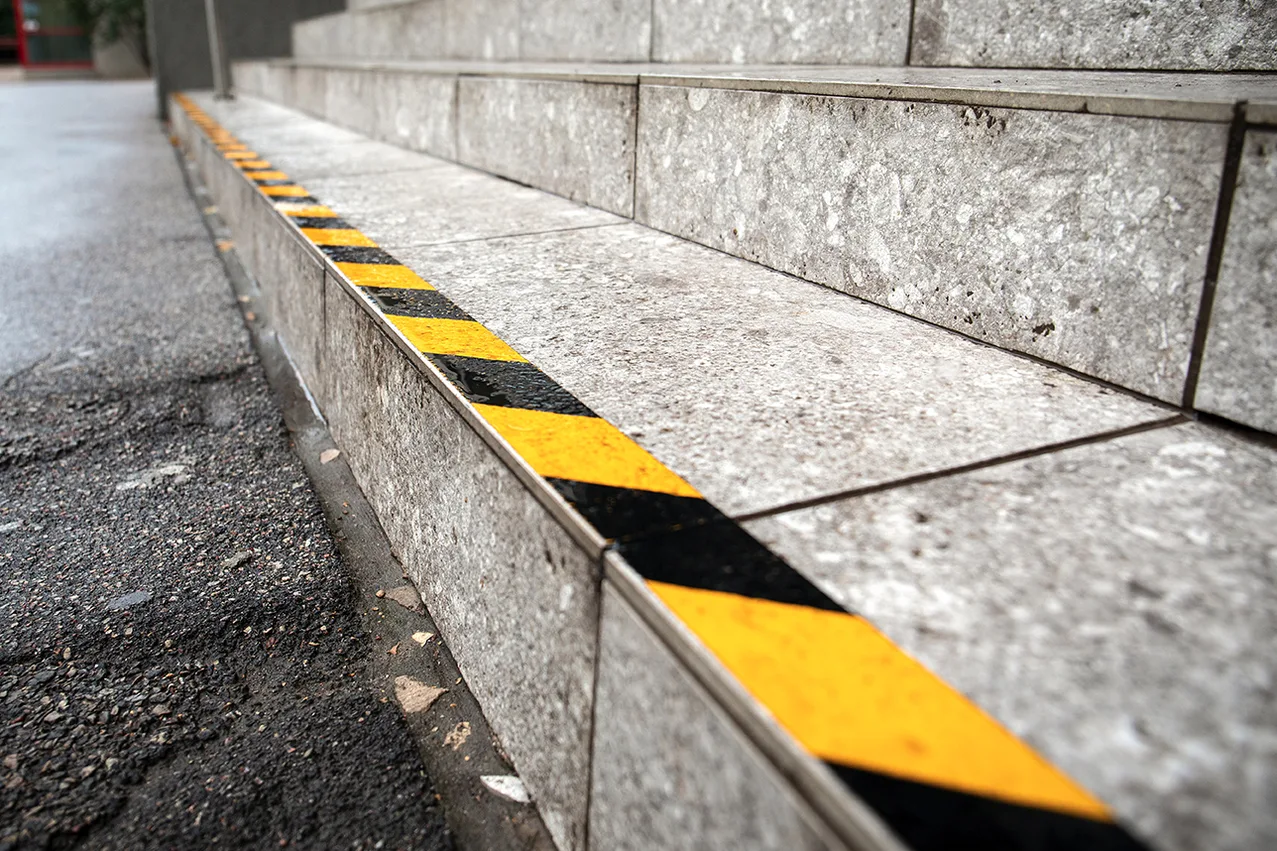 Slip and fall lawyer for staircase injuries Slip and fall lawyer evaluating a dangerous staircase behind a premises liability injury claim